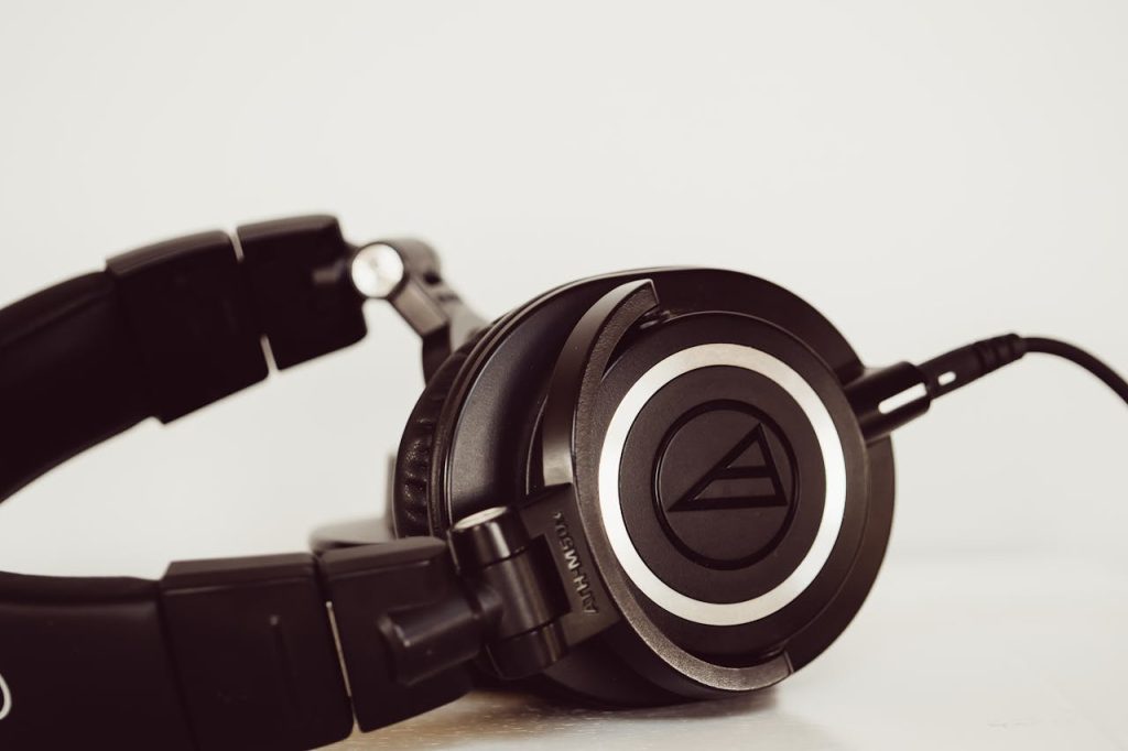 High-quality black studio headphones close-up, ideal for music and audio production environments.